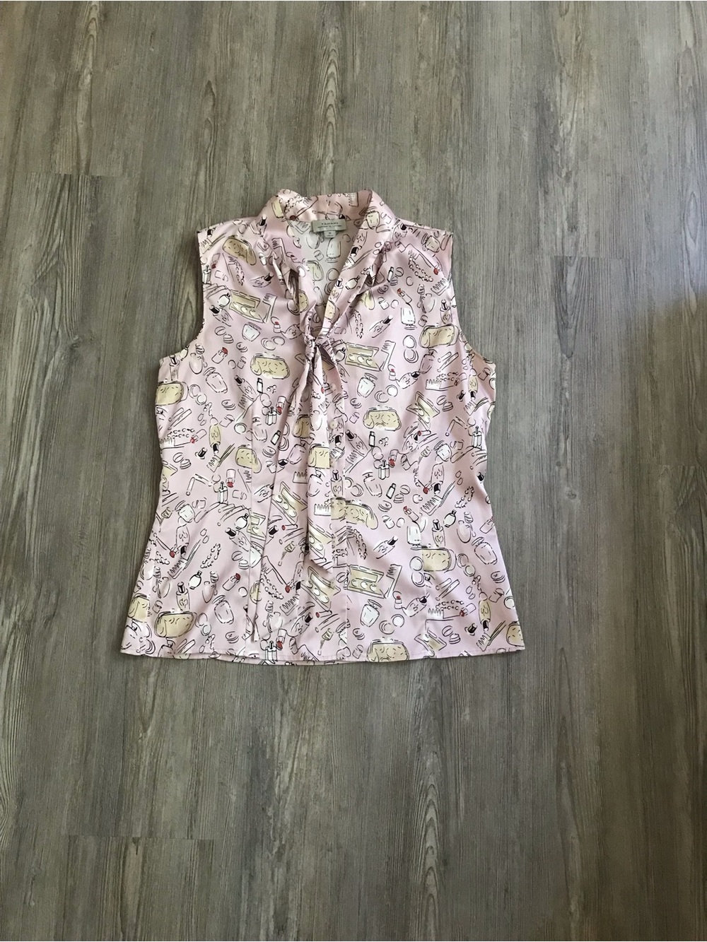 Sleeveless Tie-Neck Blouse in Pale Pink with Cosmetic Print